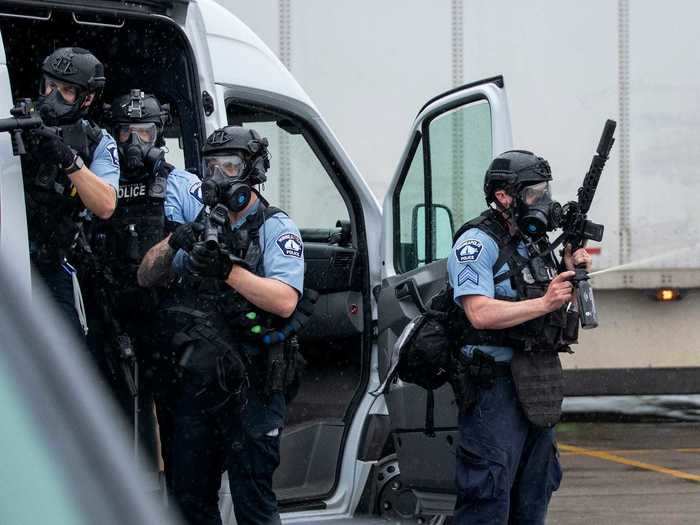 Police responded by forming a barricade around the precinct, fully dressed in riot gear.