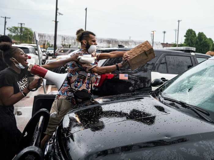 Some protesters were seen throwing bricks and rocks at empty police cars.