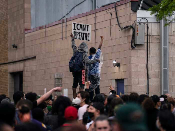 Four police officers involved were fired on Tuesday, and protesters demanded they be charged with Floyd