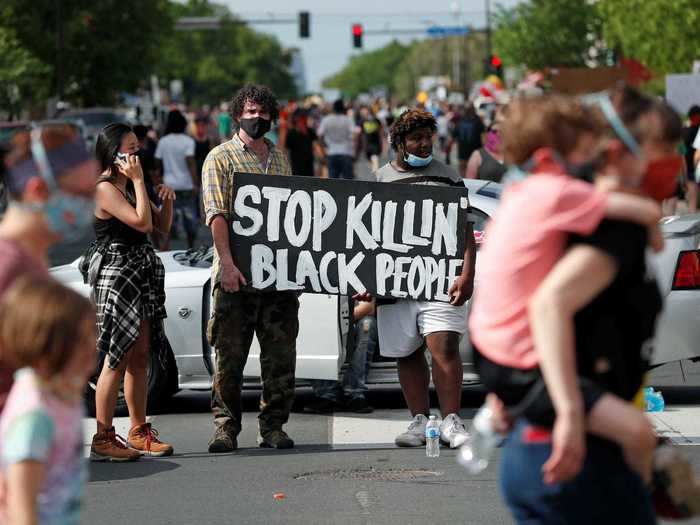 The protests began at the scene were Floyd was killed. People gathered with signs saying "Stop killin