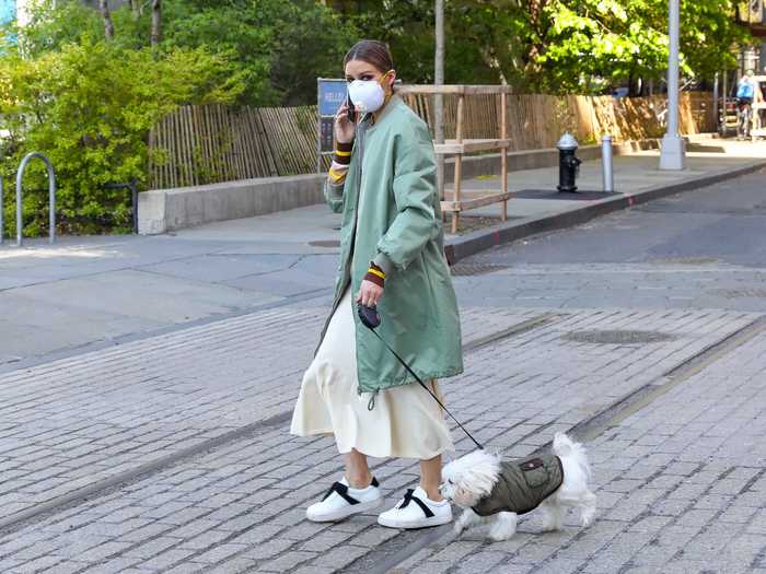 Reality star and fashion mogul Olivia Palermo wore an elegant green coat while taking a walk with her dog.