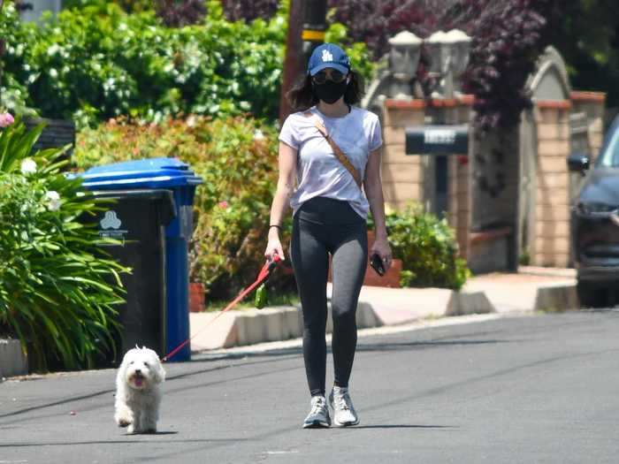 "Pretty Little Liars" star Lucy Hale wore a comfortable outfit and donned a mask for a walk with her dog.