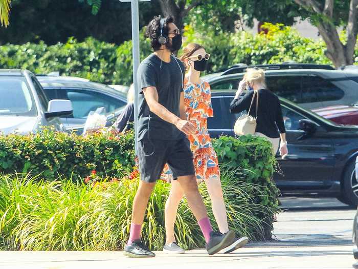 "Slumdog Millionaire" star Dev Patel and his girlfriend, Tilda Cobham Hervey, sported matching black masks while on a walk in Los Angeles.