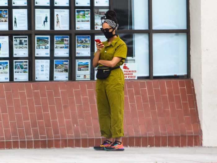 "Riverdale" star Asha Bromfield wore a stylish green jumpsuit with a matching black mask and fanny pack.