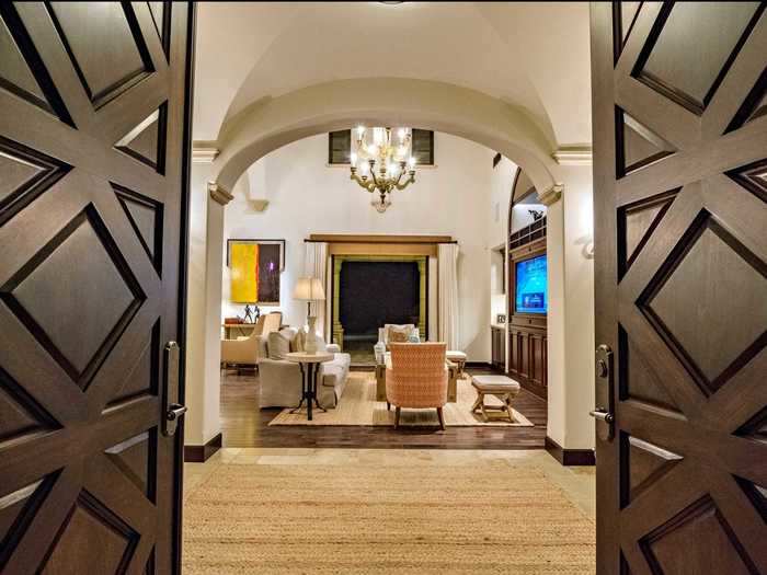 Heavy double doors open up to an entryway ...