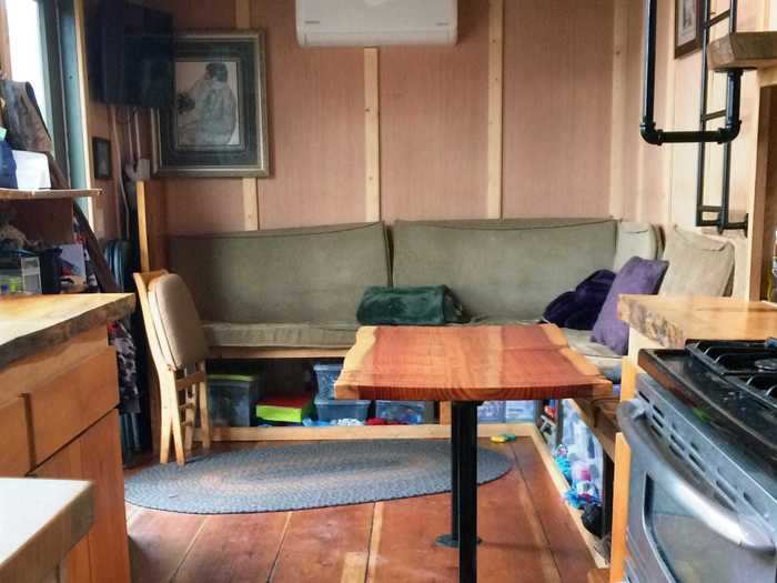 The living space is opposite the kitchen and has a couch and table.