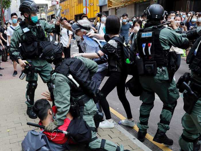 Dressed in full riot gear, police stopped and searched younger people, while detaining large groups of protesters.