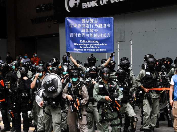 Holding up warning flags, the police blocked off roads, and threatened to arrest protesters.