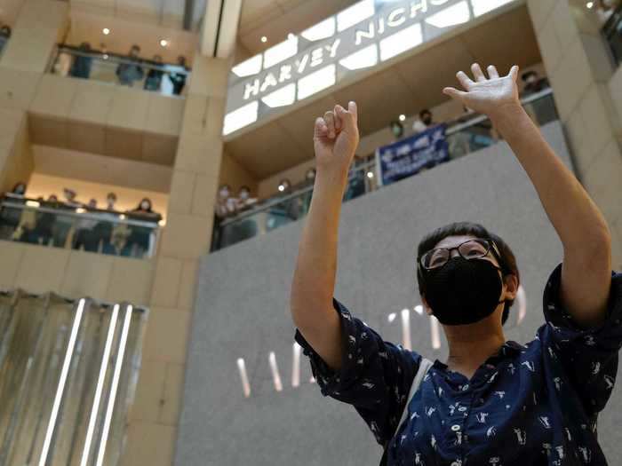 Protesters held their hands up as a symbol of the "five demands" — a list of freedoms that pro-democracy protesters have been fighting for since last year.