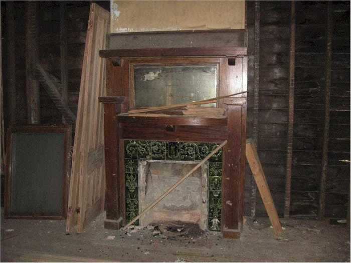 Underneath planks of wood, future owners will find gorgeous historic fireplaces like this one.