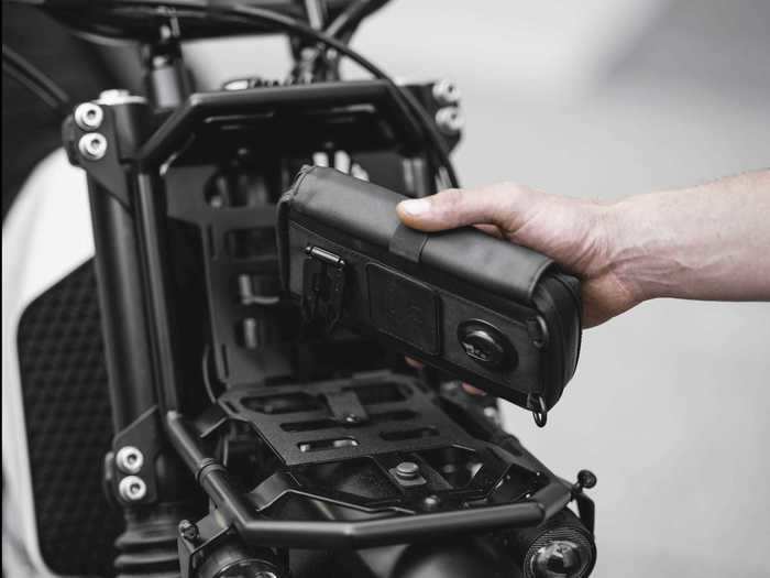 A custom rack on the motorcycle carries extra fuel for long trips.