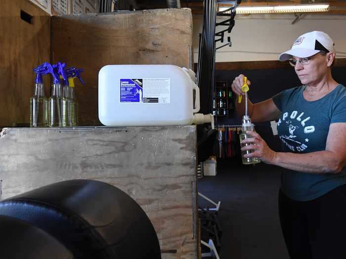 Gymgoers may even be assigned their own spray bottle to encourage frequent sanitation of equipment.