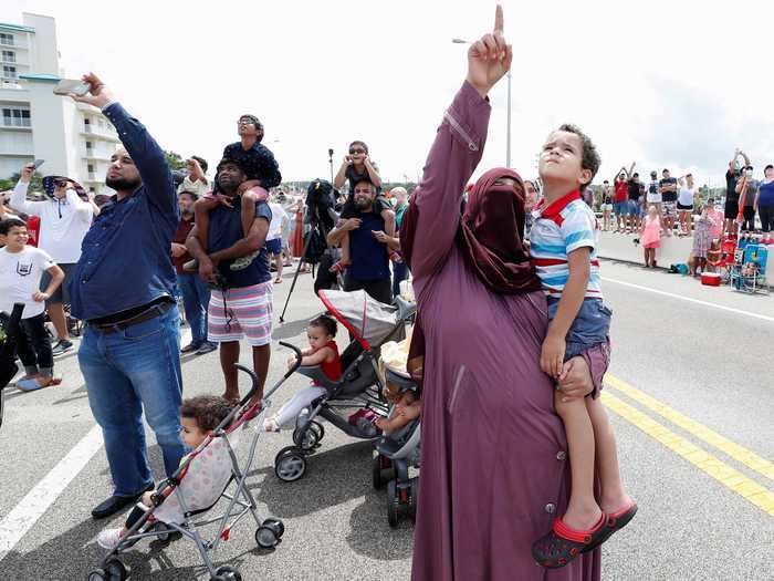 Approximately 300,000 people gathered nearby to watch the historic launch.