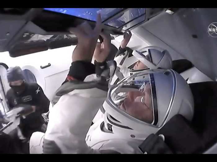 Cameras inside the Crew Dragon spaceship showed Behnken and Hurley strapped into their seats, preparing for launch. The capsule is controlled via touchscreen.