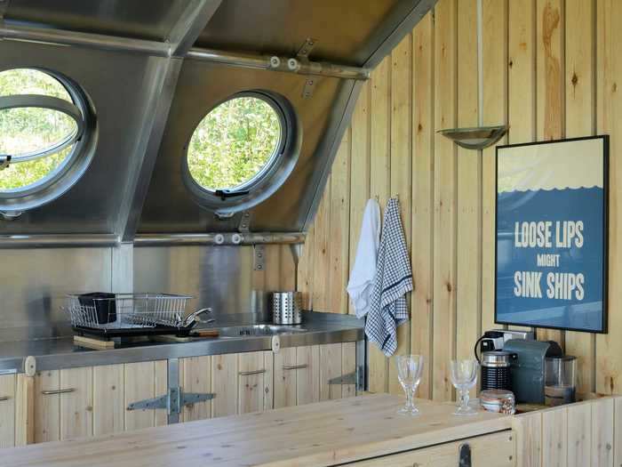 The galley worktop and nautical decor, plus portholes give the feeling of being on a ship.