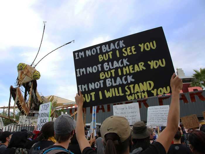 Some demonstrators used signs to declare their allyship.