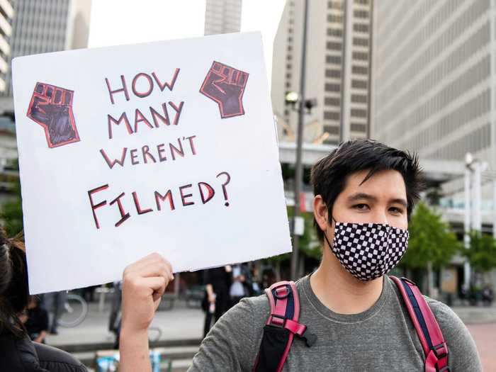 A protester marched with a sign asking, "How many weren