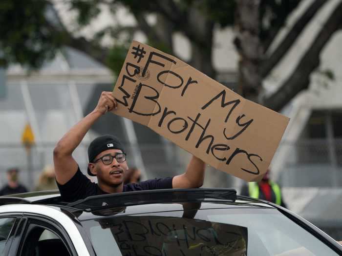 In Los Angeles, a protester held up a sign reading, "For my brothers."