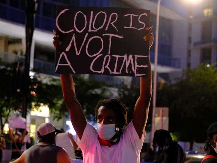 A man in Florida held a sign reading, "Color is not a crime."