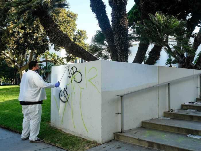 By 8 a.m., back at the courthouse, a small crew had arrived to attempt to paint over the graffiti, and try to start the day anew.