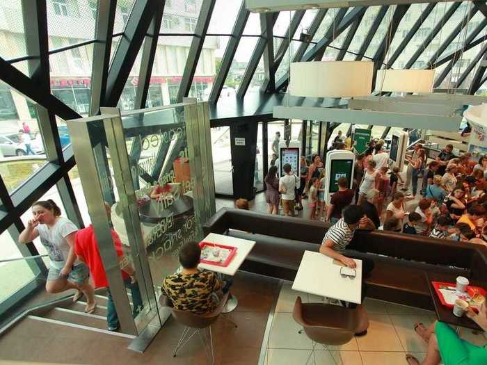 Glass stairwells mirror the surrounding glass walls.