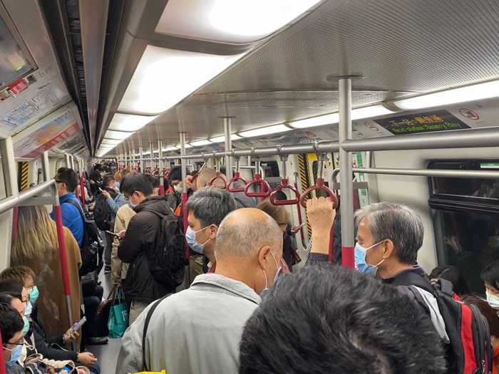 Commuters in Hong Kong continue to stand and sit next to each other. "It