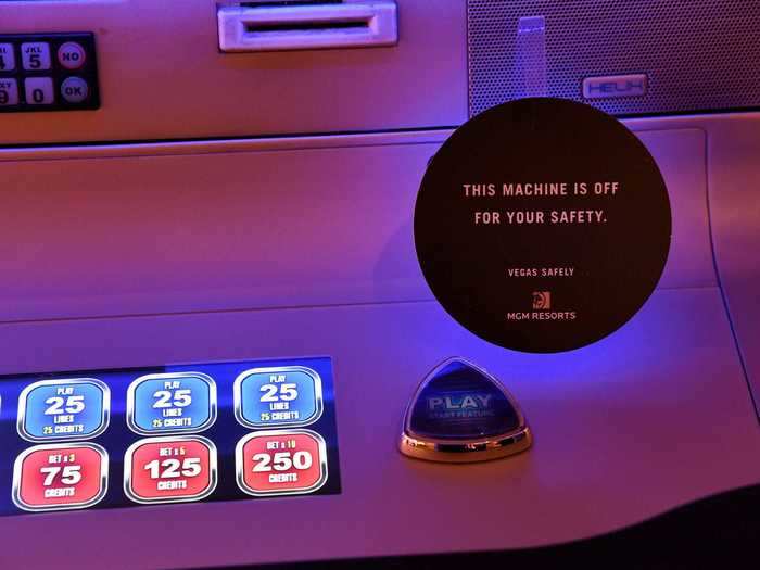 Signs on machines remind players the changes are in keeping with social distancing.