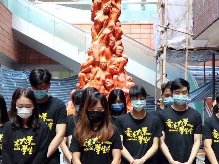 At the University of Hong Kong, students were seen taking a moment of silence in front of a statue honoring the victims of the Tiananmen Square massacre.