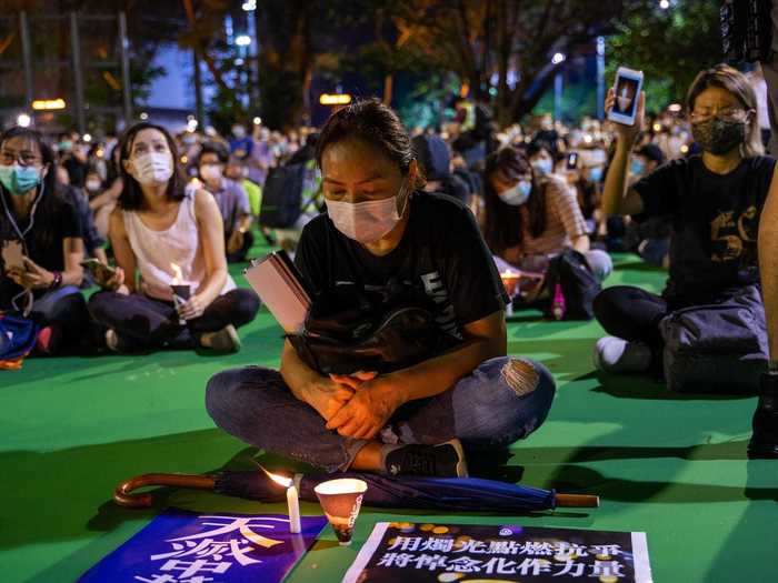 Throughout the park, many people sat peacefully and lit candles. Some played songs that were used during the 1989 protests.