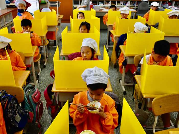 Instead of closing schools, Taiwan separated students with plastic partitions.