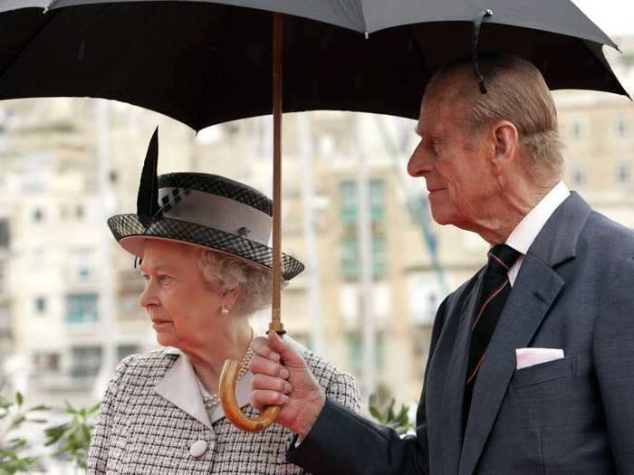 He holds his own umbrella.