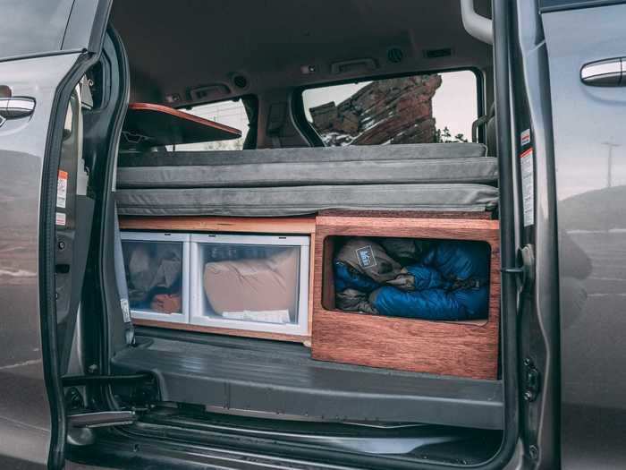 Storage in the minivan camper includes cabinets in the living room, as well as the previously mentioned drawers and shelves in the kitchen.