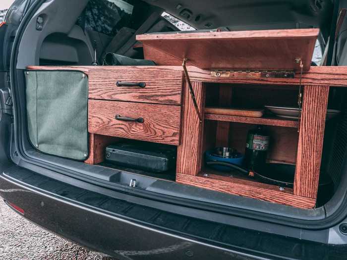 The kitchen sits at the back of the vehicle in the trunk area.