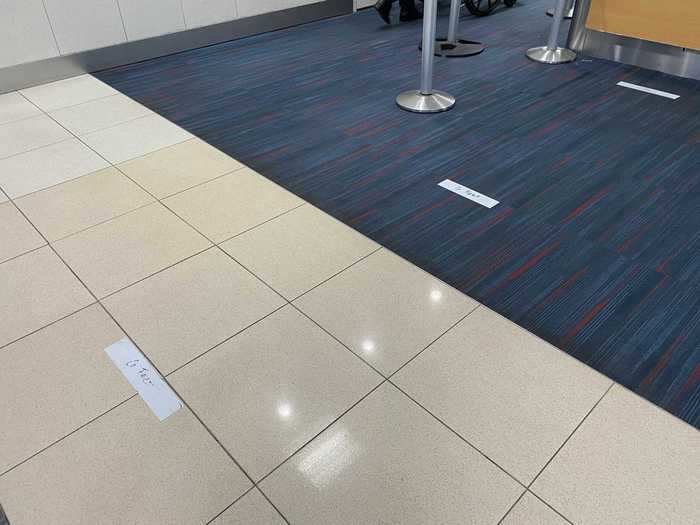 The only social distancing reminders in the gate area, however, were pieces of tape on the floor that said "6 feet" and were only for those going up to the counter, not the boarding lane.