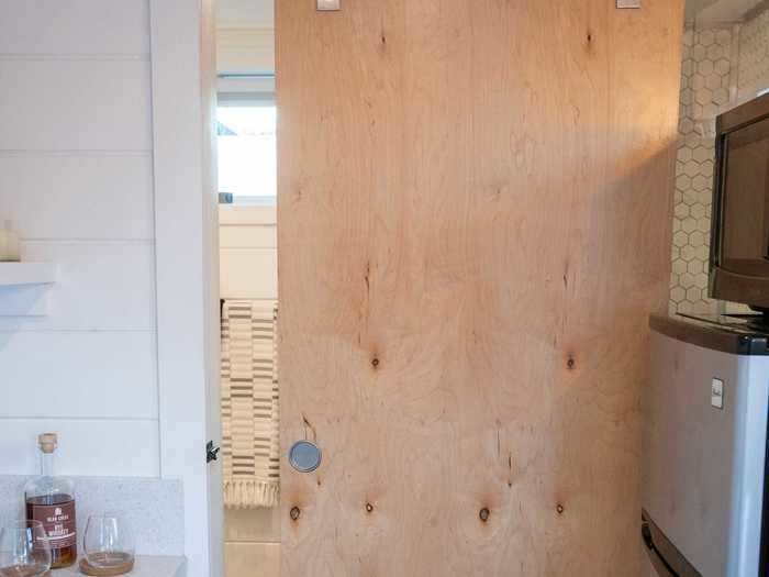 The bathroom is hidden behind a sliding door.