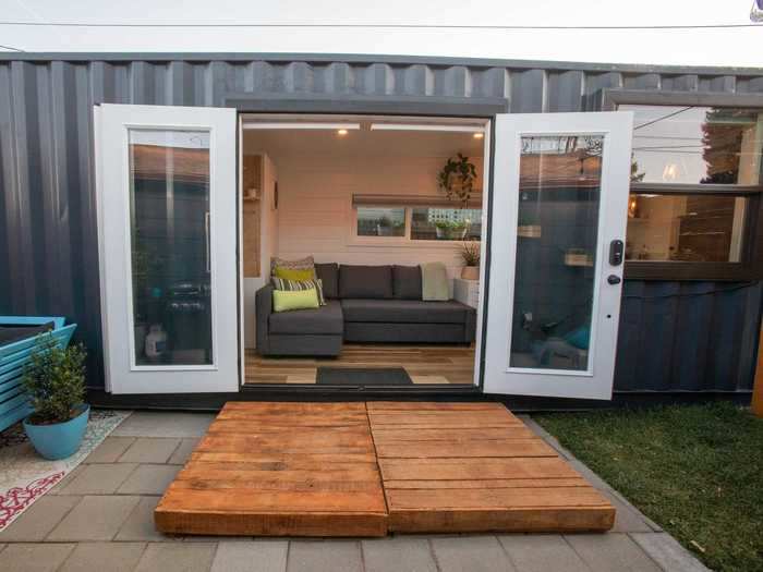 The French door entrance sits across from the living room and couch, offering a full view of the backyard.