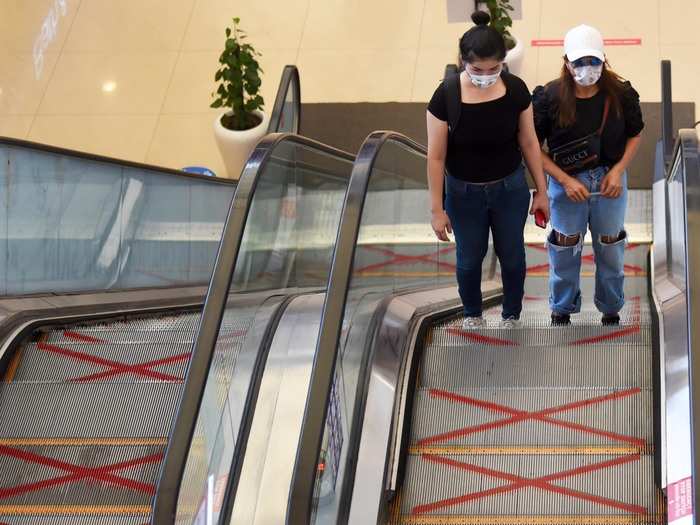 Most shops pasted stickers on the floor to help visitors maintain physical distancing and the employees wore masks, face shields and gloves.
