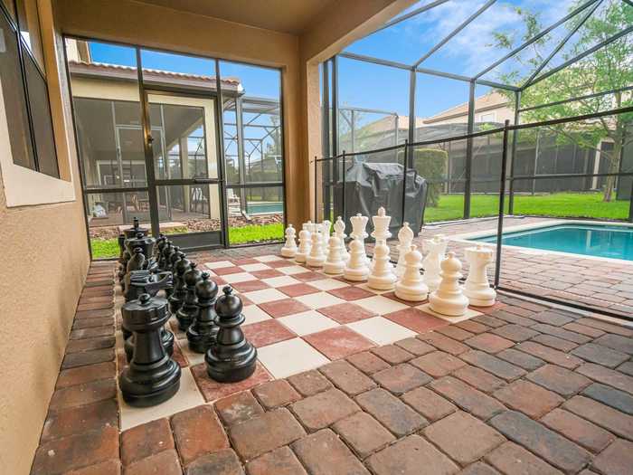 There is also an outdoor space with a heated pool, a hot tub, and a huge chessboard.