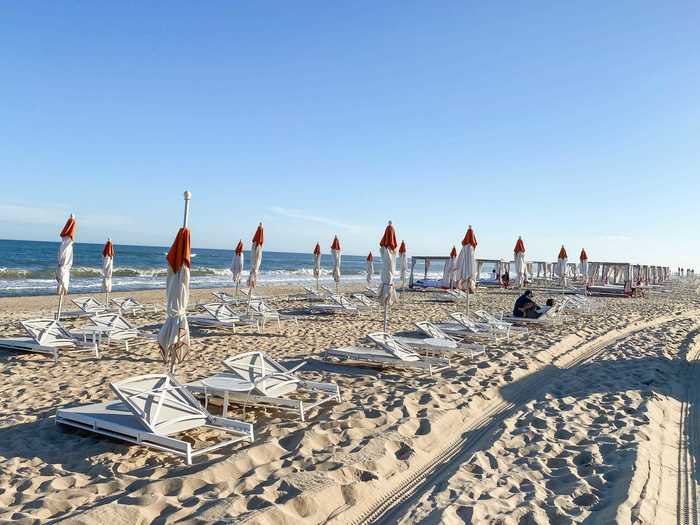 Lounge chairs and umbrellas lined the beach.