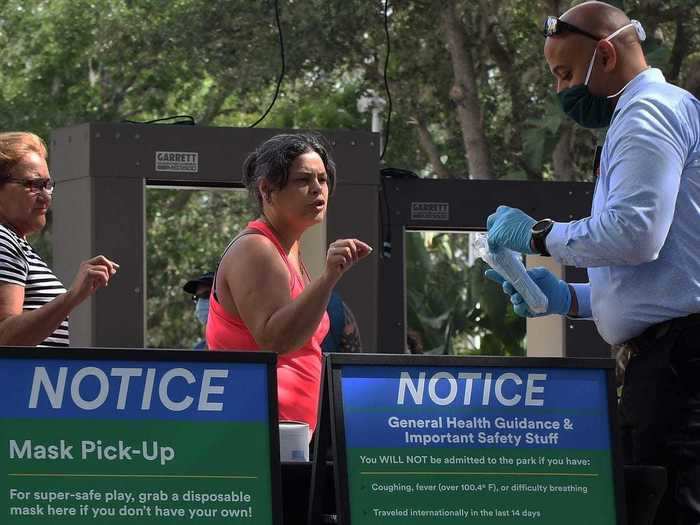 Parks like Legoland in Florida are directing employees to hand out masks to visitors.