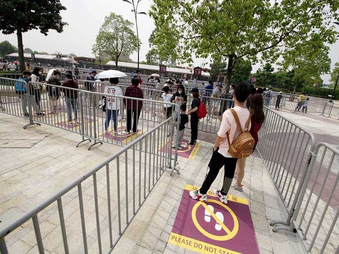 Some amusement parks will have markers showing visitors where to stand while they wait in line.