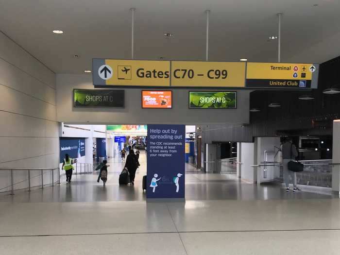 I made my way to my gate in search of food, having forgotten to pack a snack for the more than three-hour flight. Scattered along the way were signs reminding travelers to keep their distance from one another.