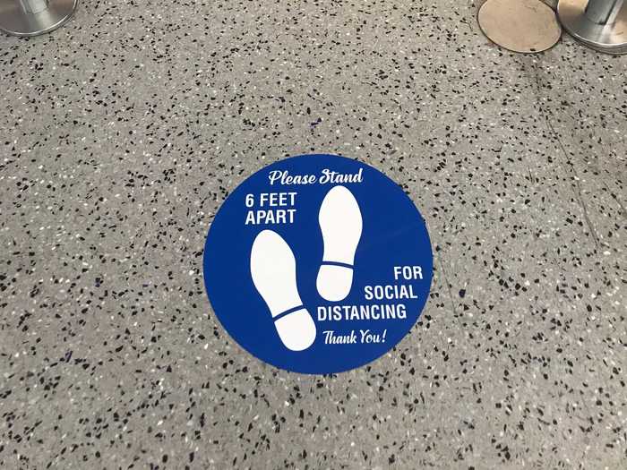 Everyone around me seemed to abide by the markers. When I approached the security desk, the TSA officer, shielded behind a glass barrier, asked me to briefly remove my mask to check my license photo.