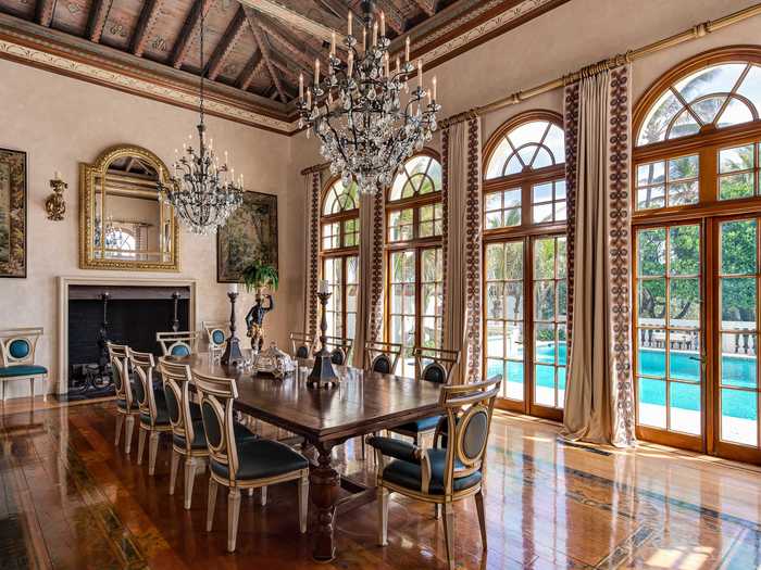 The ceilings are just one of the many rich architectural design elements throughout the estate. Polished wood floors, coquina stone accents, and intricate crown molding are seen throughout the home.