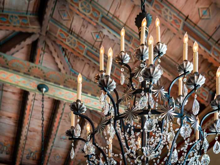 Wrought-iron chandeliers help make such detailed ceilings glitter at night.