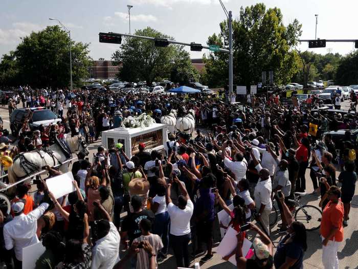 As the carriage passed by, crowds of people were heard yelling out, "Say his name," and "George Floyd."