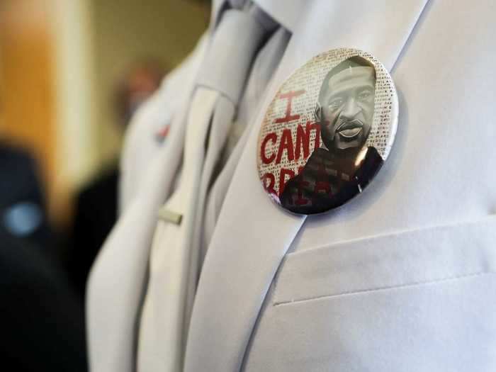 Some mourners wore buttons and masks with Floyd