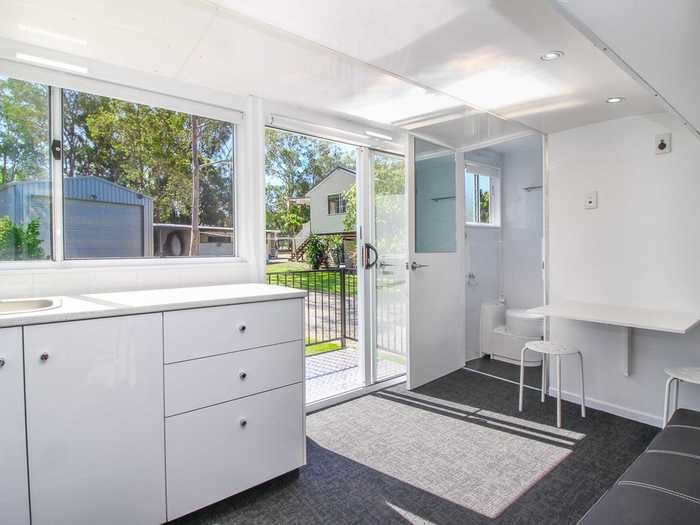 The table — which sits besides the bathroom — is accompanied by two stools.