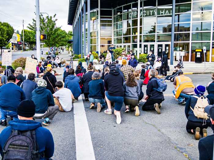 Pictured on June 5, a crowd of a hundred people marched through downtown Olympia, Washington ...