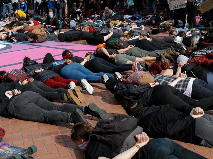 In Portland, Oregon, protesters are seen lying on the ground with their hands behind their back to signify how Floyd spent his final moments before he was killed.